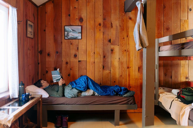 A woman reading a book in the dorm