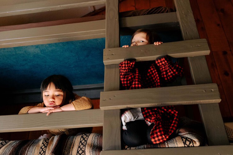 Kids sitting on a bunk bed